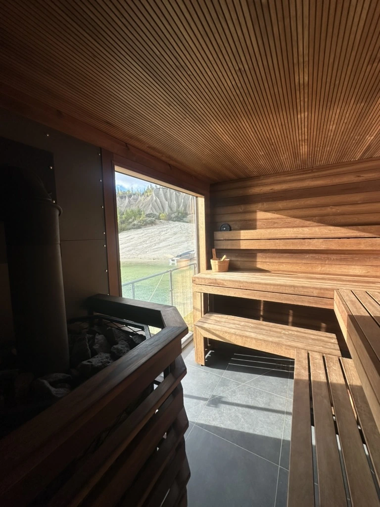 Wood stove and panoramic window inside the Usinsh IV sauna room