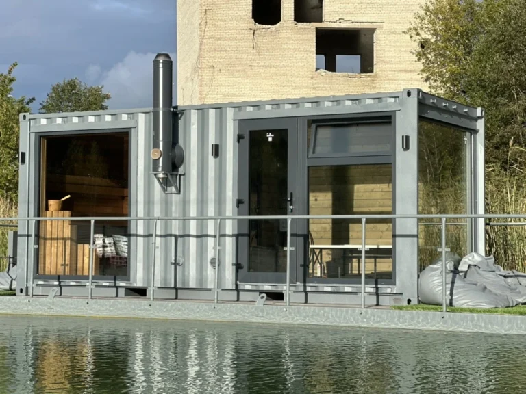 Shipping container sauna Usinsh IV with a glazed anteroom and stove chimney